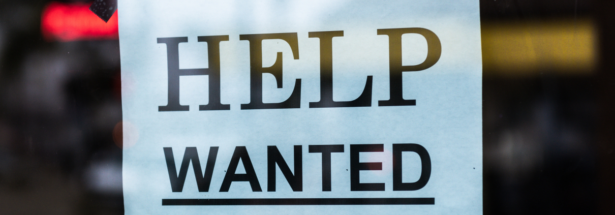 Help wanted sign in a window - for a blog post on When’s It Time To Hire Help For Your Social?